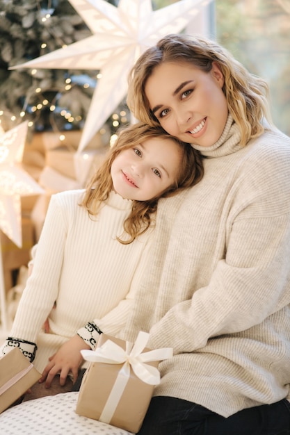 Portrait of mom and daughter in Christmas time. Happy family spent time together during the holiday