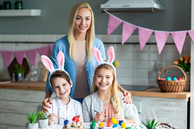 Portrait of mom with kids, easter kitchen decor.