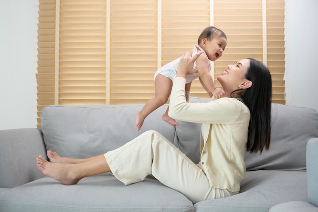 Portrait of mother and baby girl at home family child childhood and parenthood concept