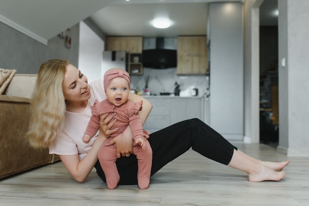 Portrait of mother and child laughing and playing