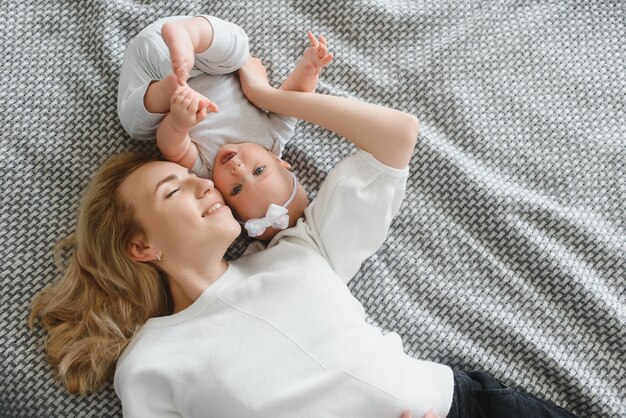 Portrait of mother and child laughing and playing