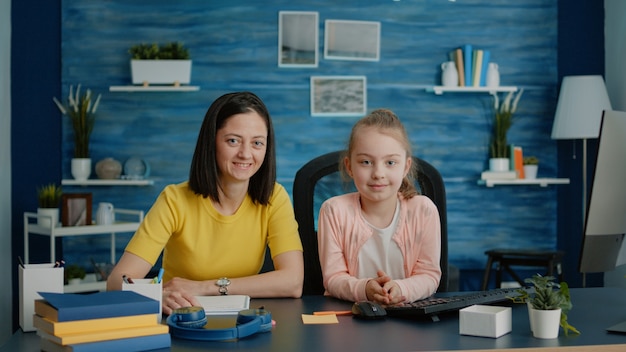 Photo portrait of mother and child prepared for online classes