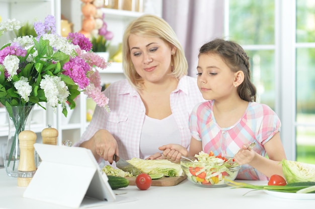 Portrait of mother and daughter cooking together