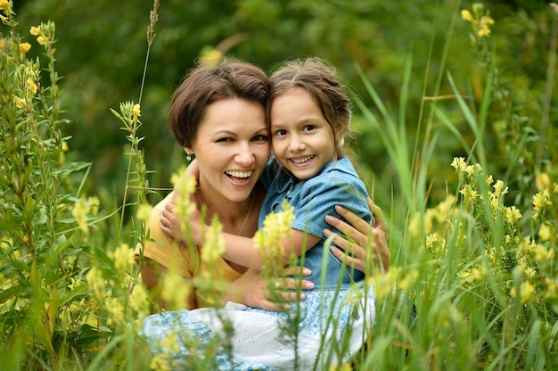 Portrait of mother and daughter at field