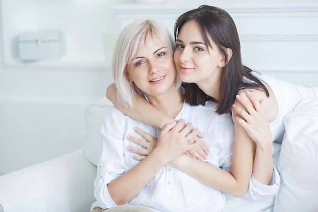 Portrait of mother and daughter at home