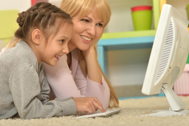 Portrait of mother and daughter using computer