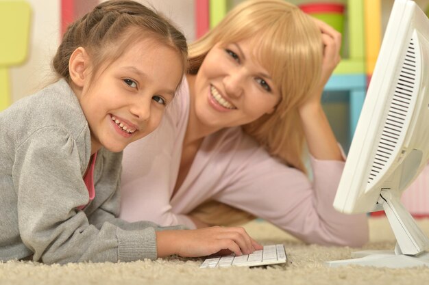 Portrait of mother and daughter using computer