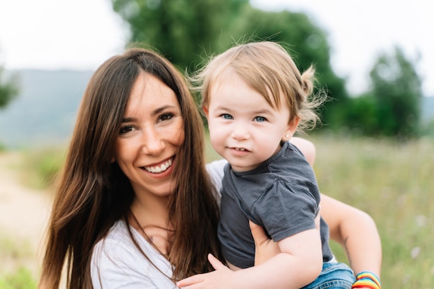 Portrait of a mother holding her son outdoors