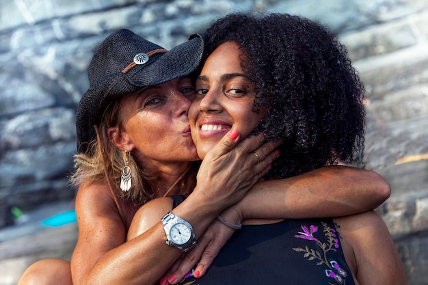 Portrait of mother kissing on daughter cheek