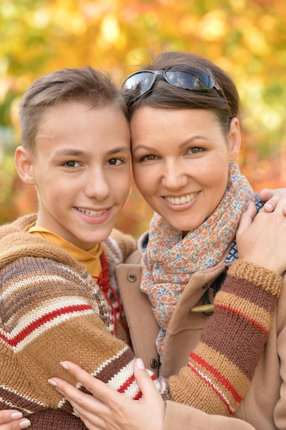 Portrait of mother and son in autumn park