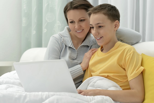 Portrait of a mother and son using laptop together