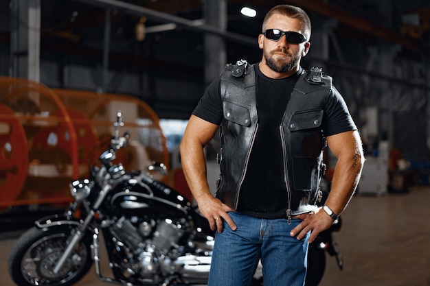 Portrait of motorbike rider in black leather outfit