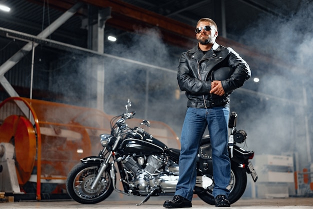 Portrait of motorbike rider in black leather outfit