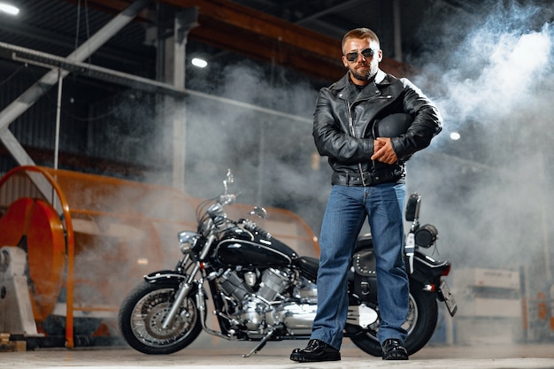 Portrait of motorbike rider in black leather outfit