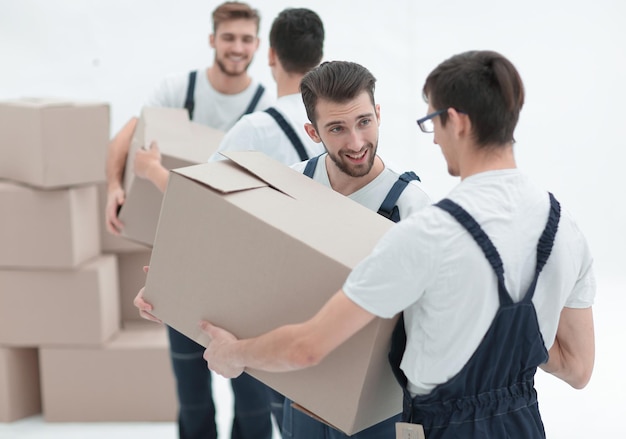 Portrait of movers holding box smiling isolated on white backgro