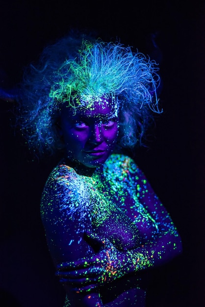 Portrait of multi colored light painting against black background
