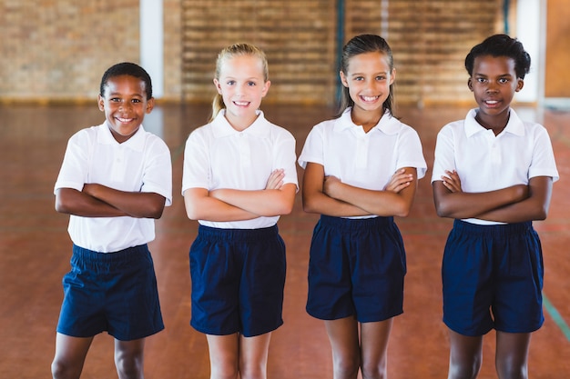 Portrait of multi-ethnic school kids standing with arms crossed