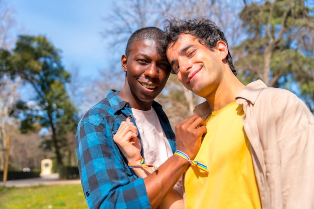 Portrait of multiethnic gay male couple on a romantic walk in the park lgbt concept