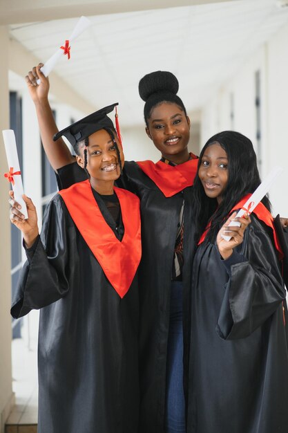 Portrait of multiracial graduates holding diploma