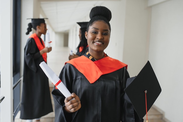 Portrait of multiracial graduates holding diploma