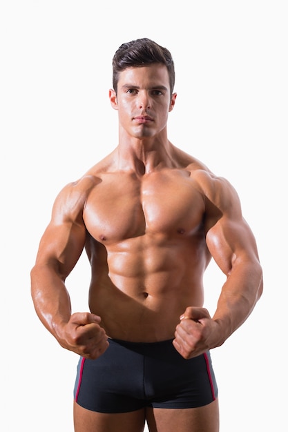 portrait of a muscular man clenching fists