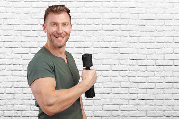 Portrait of a muscular man lifting weight