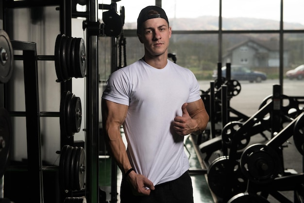 Portrait Of A Muscular Man In Shorts And White Tshirt Posing