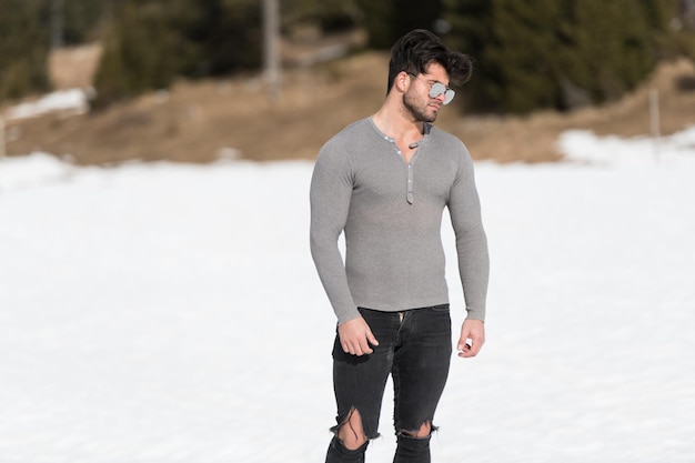 Portrait of Muscular Man Standing Outdoors in Nature