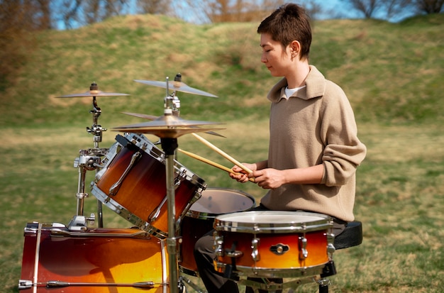 Photo portrait of musician playing percussion instrument for world music day