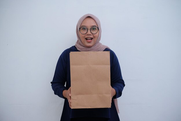 Portrait of muslim woman holding paper bag