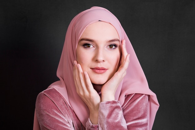 Портрет мусульманская женщина позирует на черном фоне