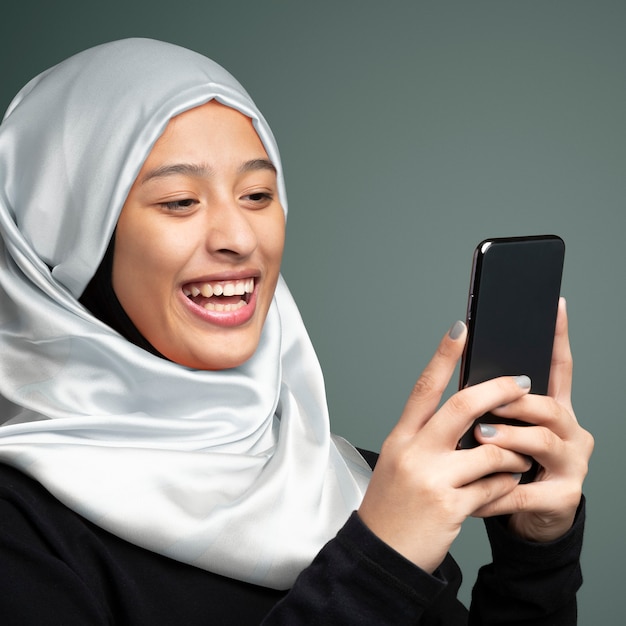 Portrait of a muslim woman using a mobile phone