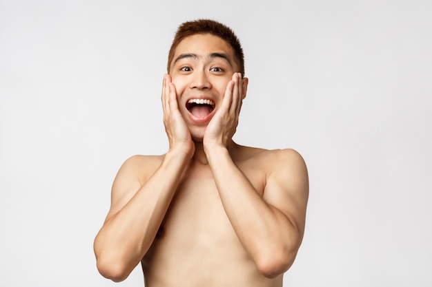 Portrait naked Asian man showing gesture.