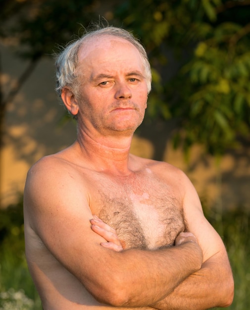 Foto ritratto di uomo nudo su sfondo naturale