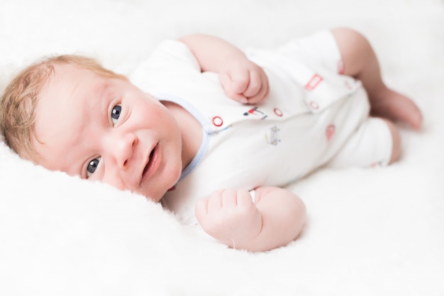 Portrait of a newborn baby boy in a cap