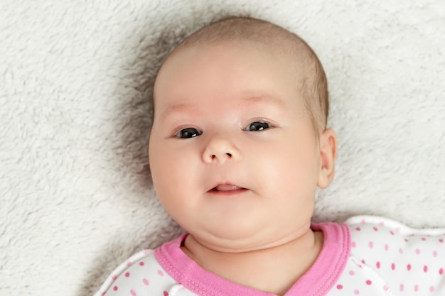 Portrait of a newborn baby dressed a shirt in polka dot closeup