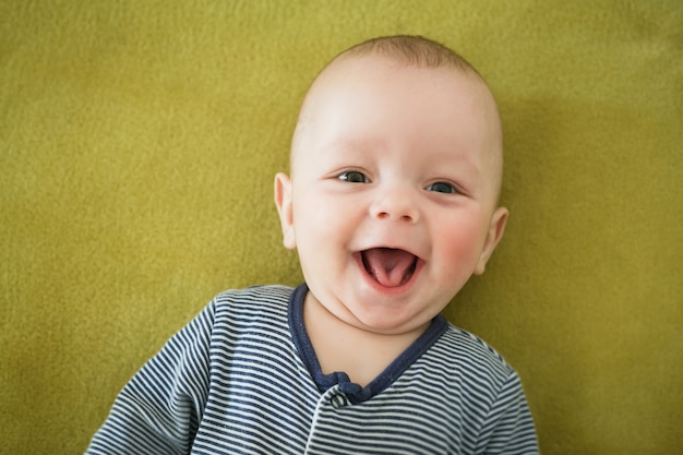 Portrait of  newborn boy is lying in the bed