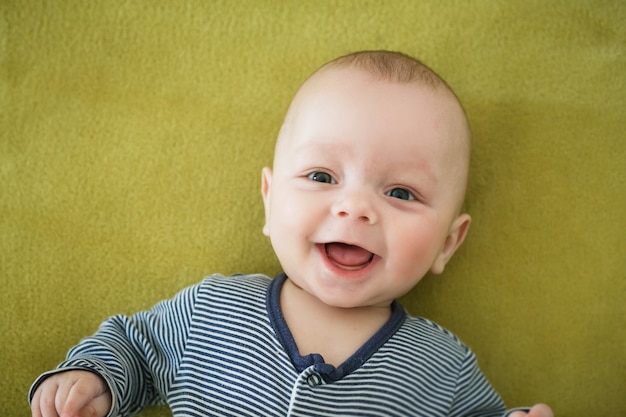 Portrait of  newborn boy is lying in the bed