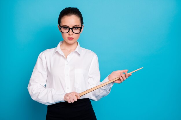 Portrait of nice attractive coacher holding in hands wooden stick secondary school isolated over bright blue color background