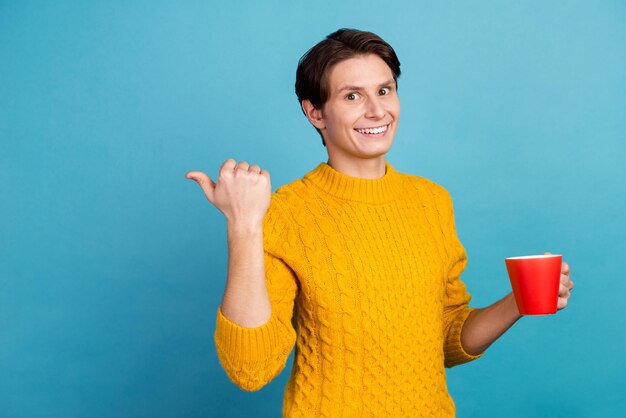 Portrait of nice attractive guy point empty space espresso morning aroma isolated over blue color background