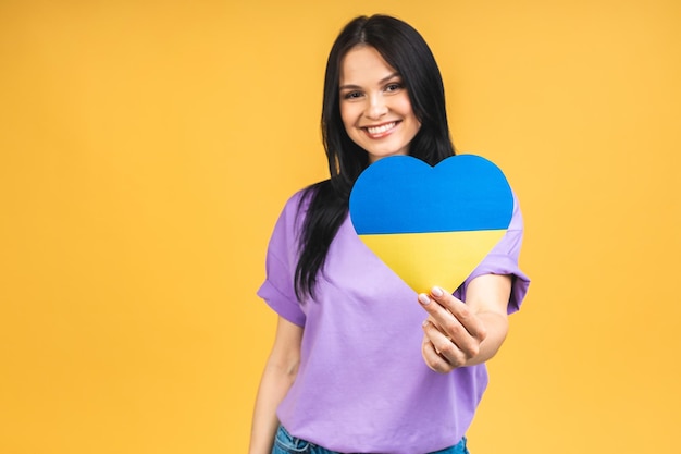 Portrait of nice beautiful lovely glad cheerful woman holding in hands Ukrainian flag having fun