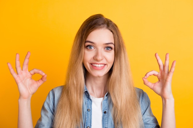 Portrait of nice lovely cheerful girl showing oksign ad solution good choice isolated on bright vibrant background