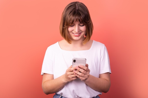 portrait of nicelooking lovely pretty cheerful brownhaired woman using digital device chatting