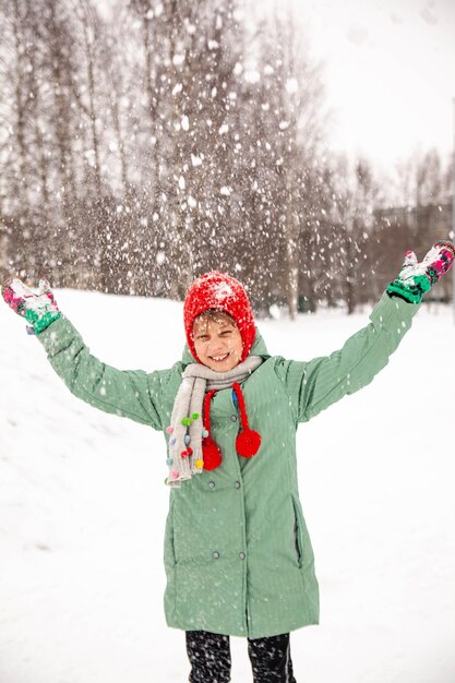 Portrait of nineyearold girl in winter coat on walk in winter