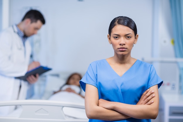 Portrait of nurse standing with arms crossed