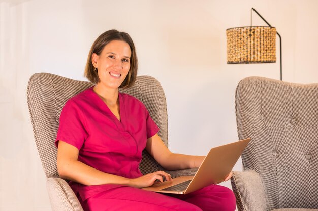 Portrait of a nutritionist with uniform working on remote sitting at home