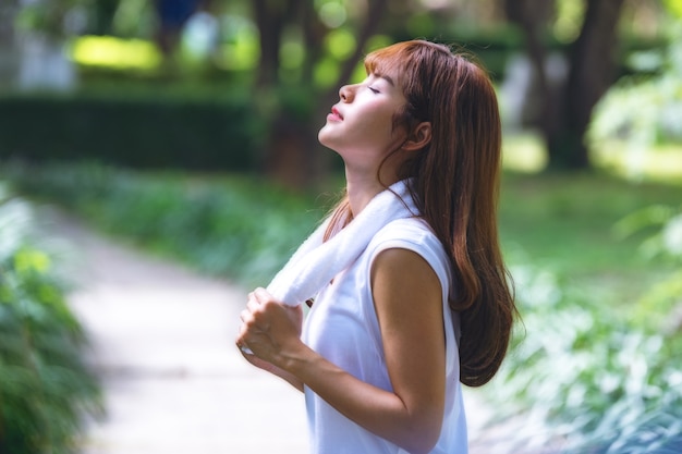 写真 晴れた日に公園でジョギングした後に休む美しい十代の女性の肖像画