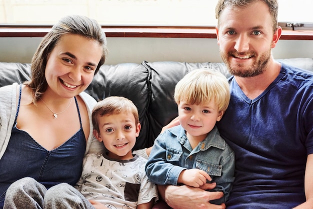 Фото Портрет счастливой семьи, сидящей дома на диване