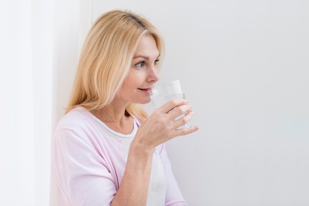 写真 素敵な年配の女性が水を飲むの肖像画