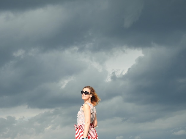 写真 空に向かって立っている女性の肖像画